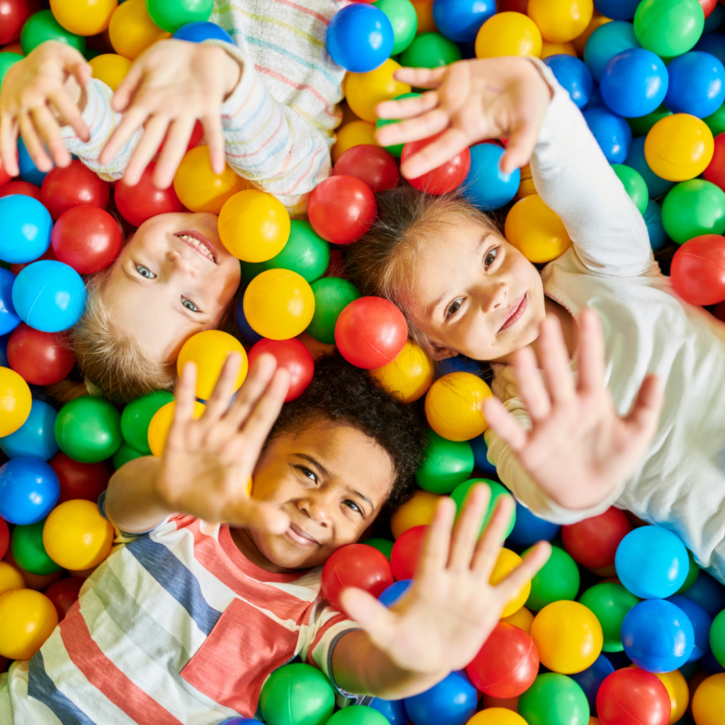 2 girls and boy enjoying the sensory ball pit during speech therapy